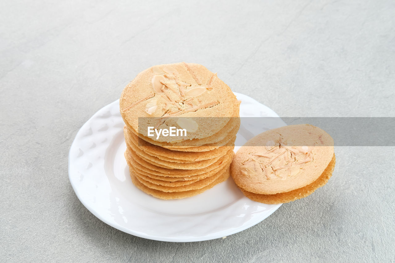 Almond crispy cookies with grated cheese, thin texture