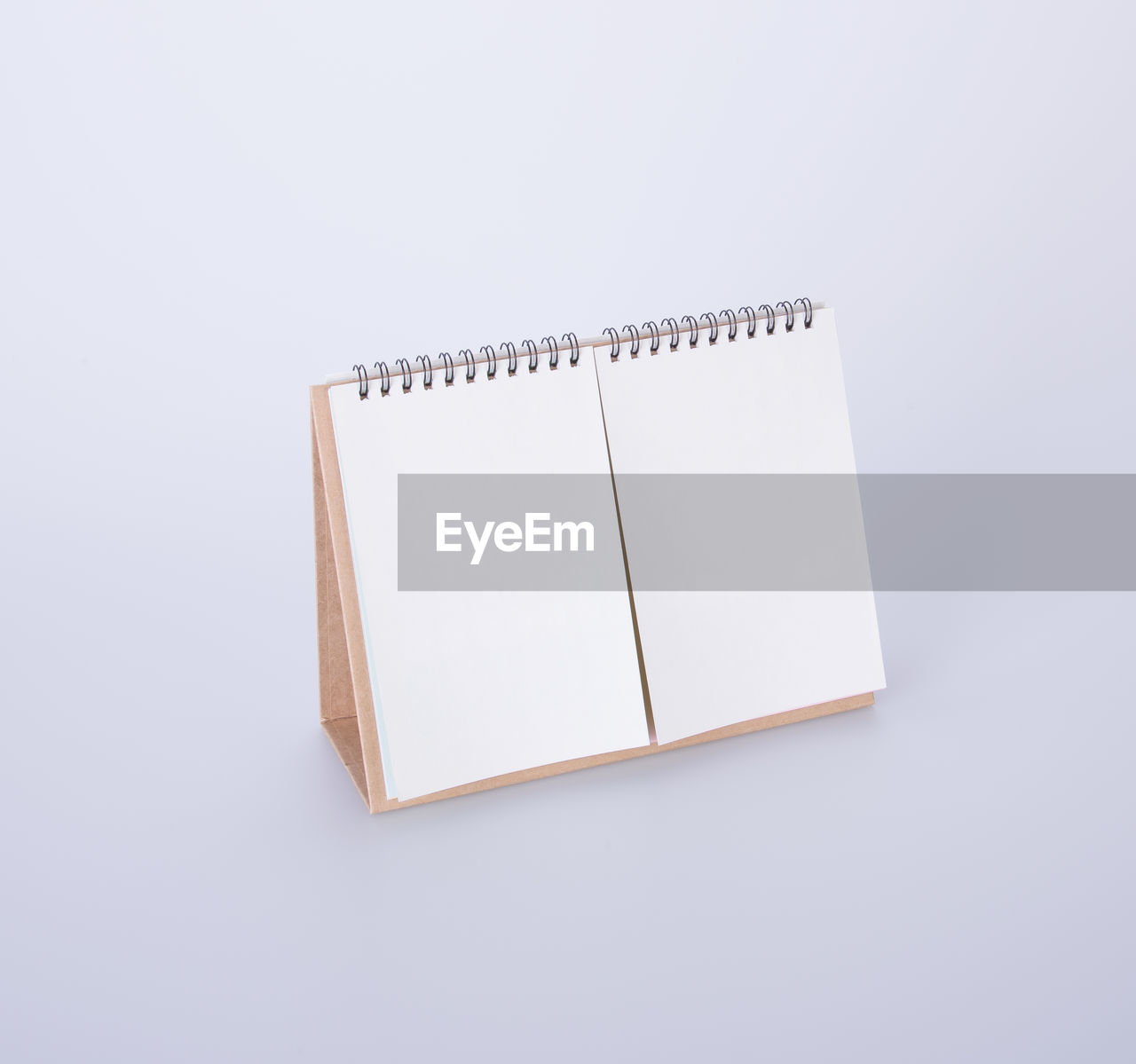 High angle view of blank desk calendar over white background