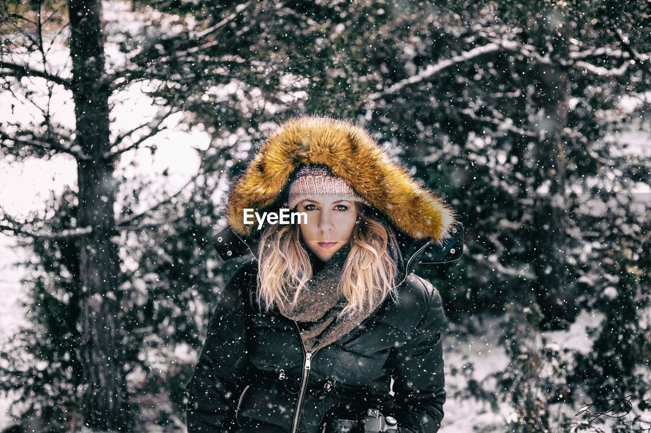 Portrait of woman in warm clothing during snowfall