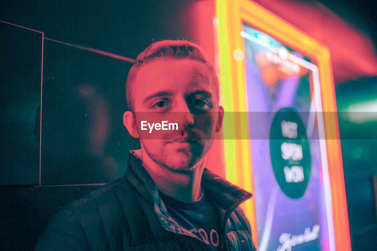 PORTRAIT OF YOUNG MAN WITH ILLUMINATED LIGHT PAINTING