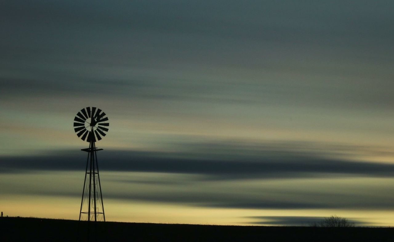 LOW ANGLE VIEW OF SILHOUETTE WINDMILL AGAINST SKY AT SUNSET