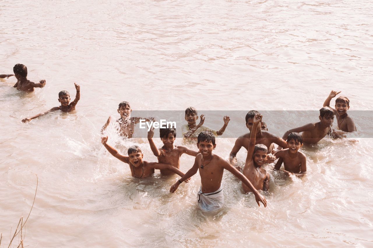 GROUP OF PEOPLE SWIMMING IN WATER