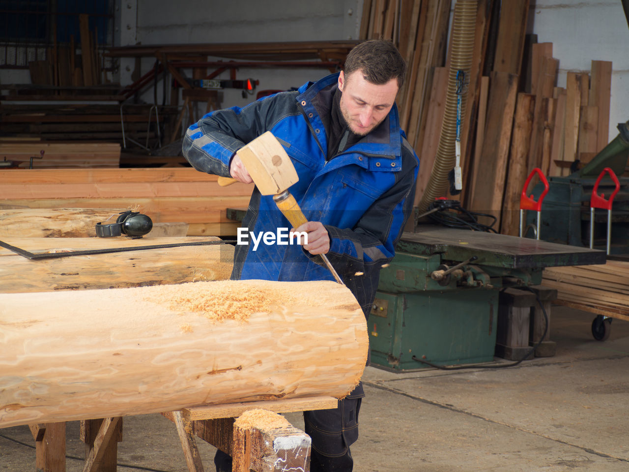 Portrait of man working on wood in workshop