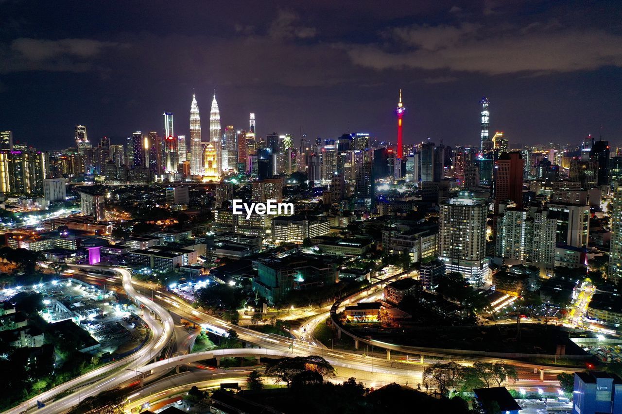 Aerial view of illuminated buildings in city at night