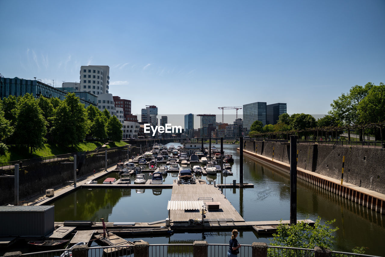 High angle view of river amidst buildings against sky