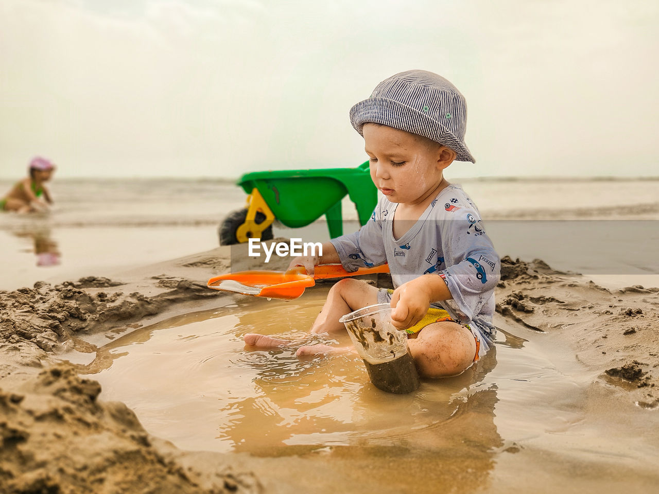 Boy playing in sand at beach