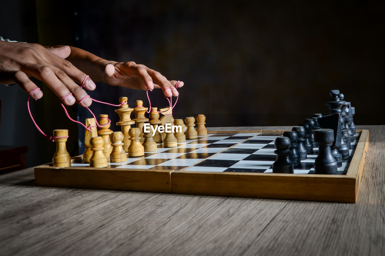 Low angle view of man playing on chess board