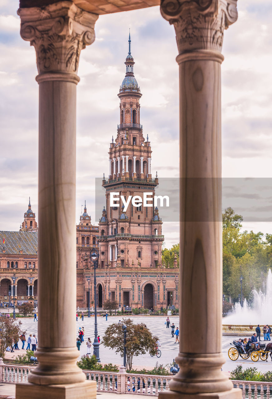 Historic building seen through columns against sky