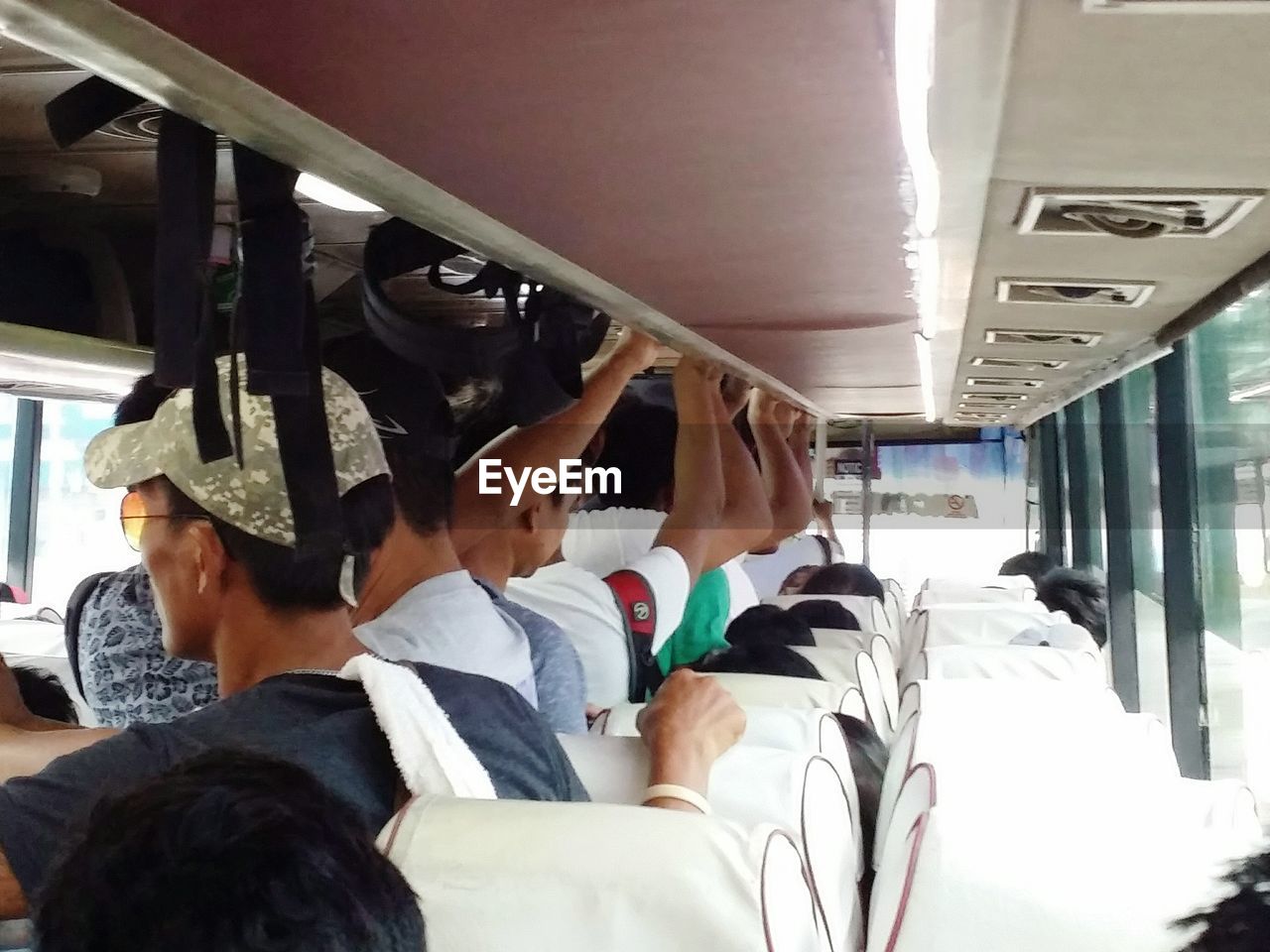 MIDSECTION OF MAN STANDING BY BUS