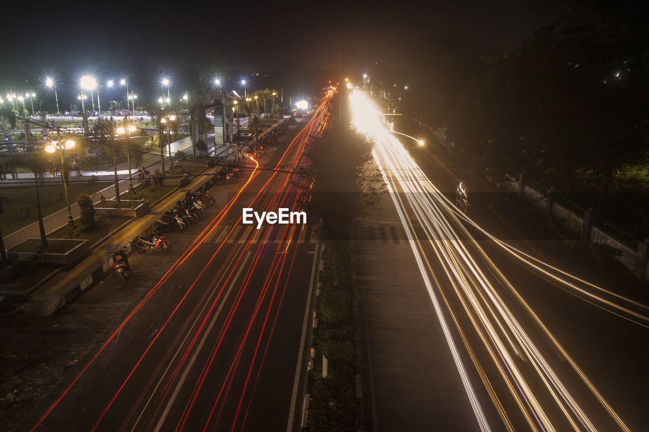 High angle view of light trails on road at night