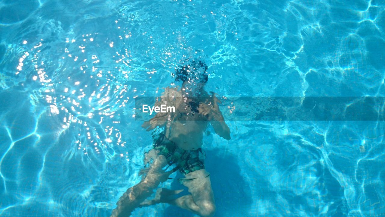 High angle view of man swimming in swimming pool