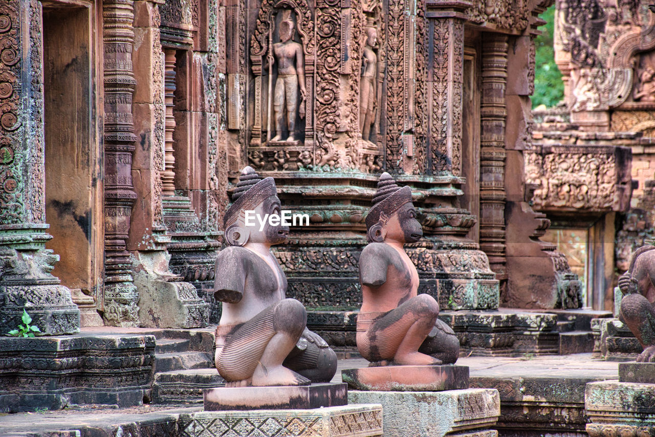 Banteay srei or banteay srey temple site among the ancient ruins of angkor wat hindu temple complex