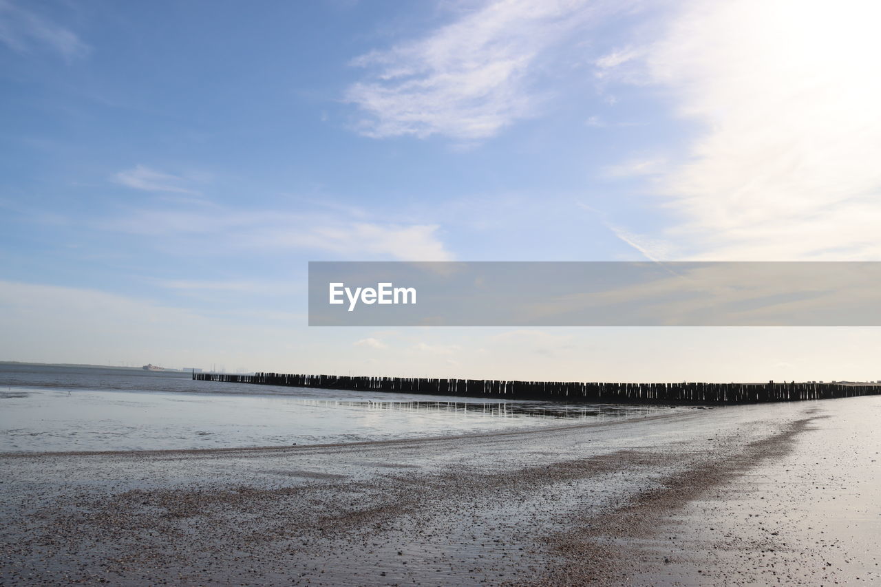 sky, beach, water, cloud, horizon, sea, shore, scenics - nature, land, wave, nature, tranquility, beauty in nature, tranquil scene, ocean, sand, coast, sunlight, body of water, no people, morning, day, reflection, outdoors, winter, non-urban scene, environment, idyllic, horizon over water