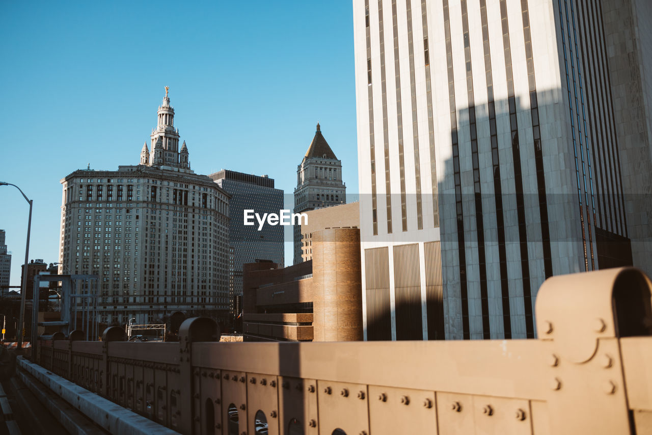 LOW ANGLE VIEW OF SKYSCRAPERS AGAINST SKY IN CITY