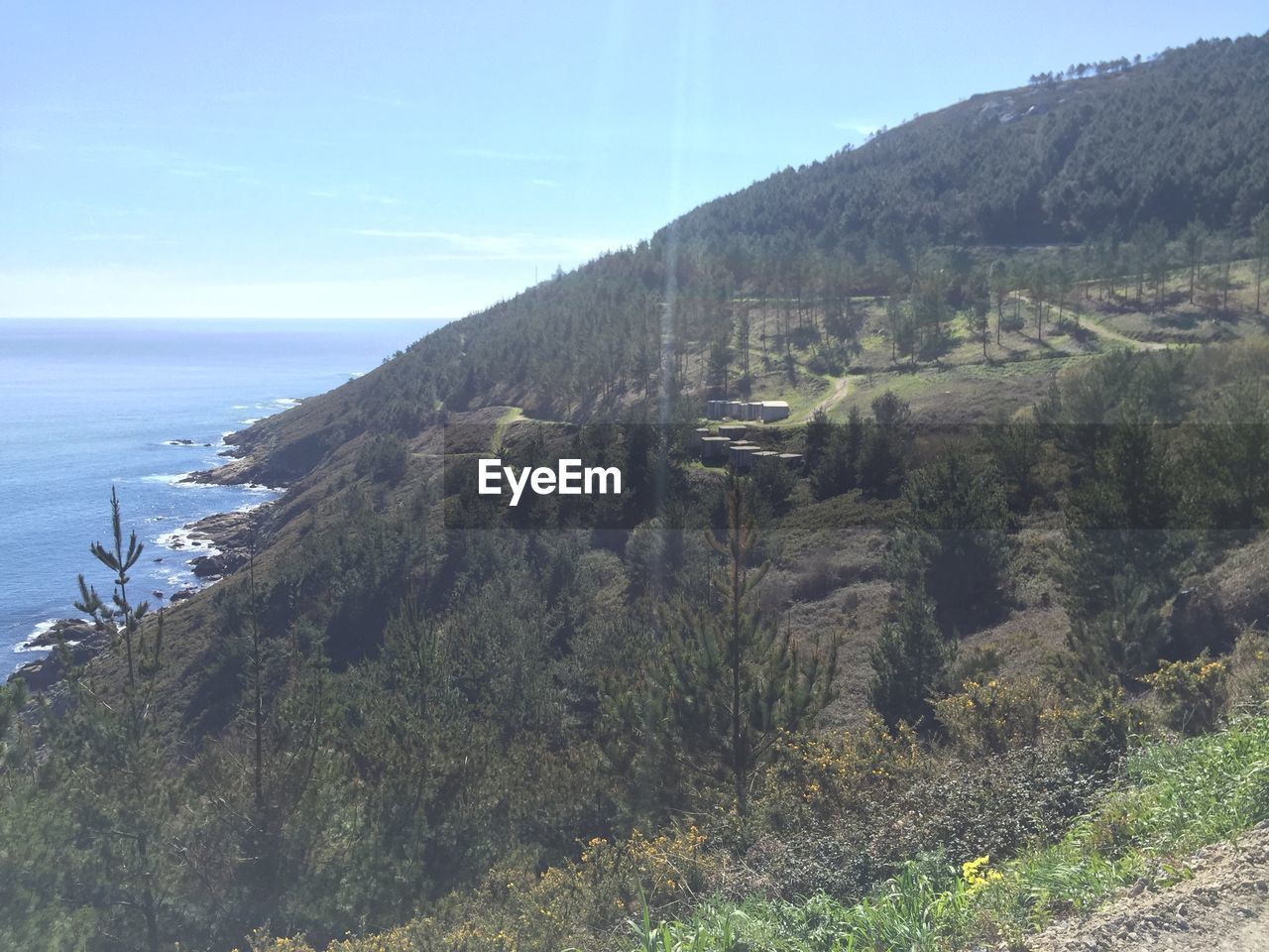 SCENIC VIEW OF SEA WITH MOUNTAINS IN BACKGROUND