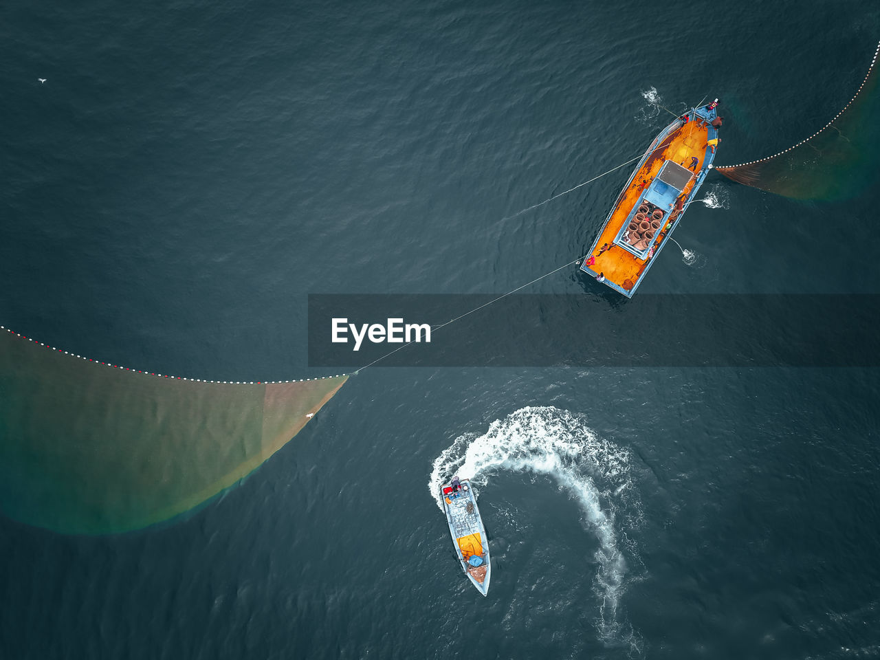 High angle view of kite flying over sea