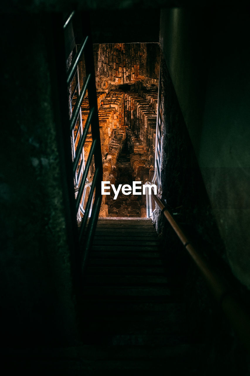 Low angle view of steps in dark building at night