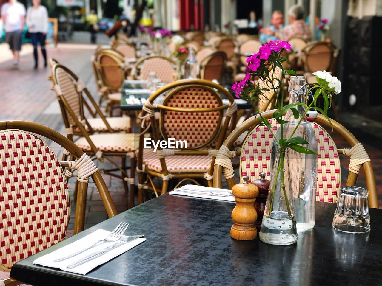 Chairs and table arranged at sidewalk cafe