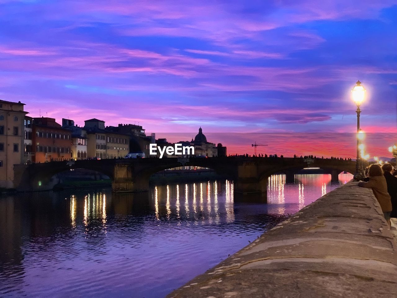 View of bridge over river at dusk