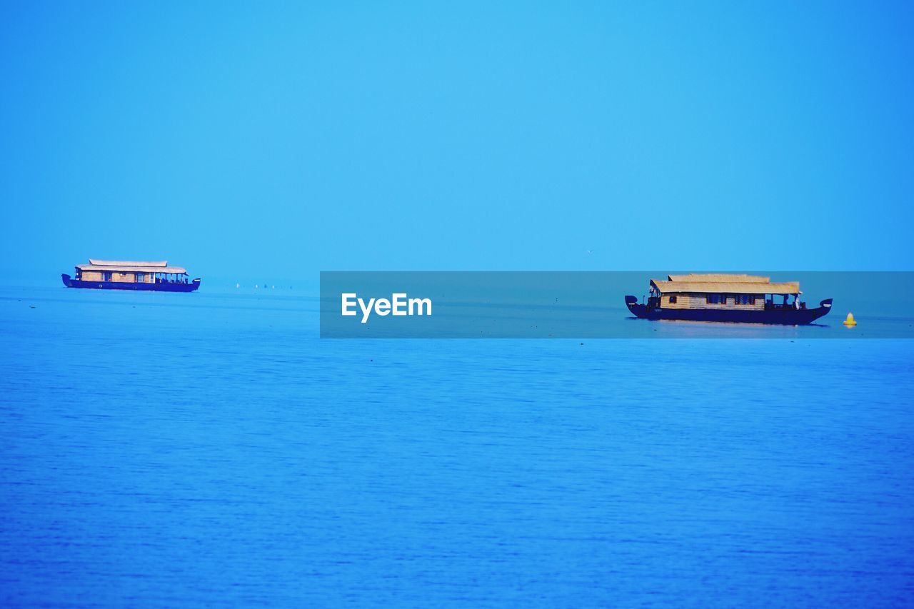 VIEW OF BOATS IN CALM SEA