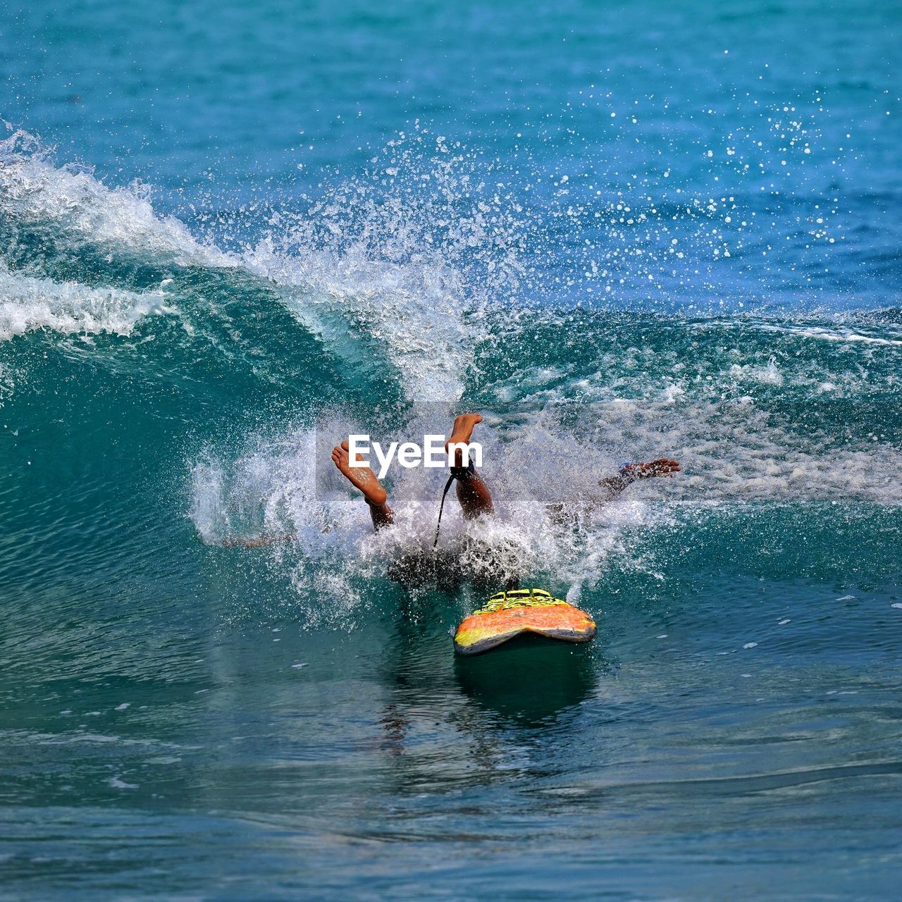 A brave man playing surfing on the ocean waves