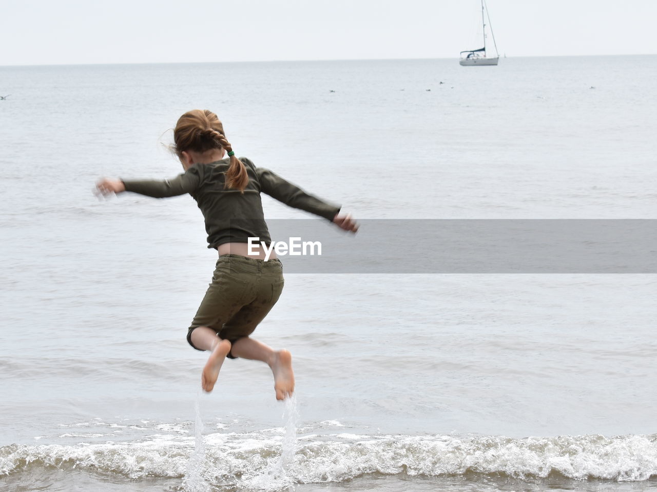 Full length of girl jumping on beach