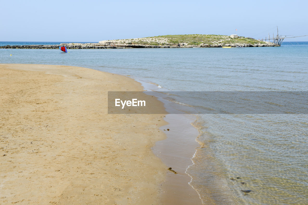 Scenic view of beach against clear sky