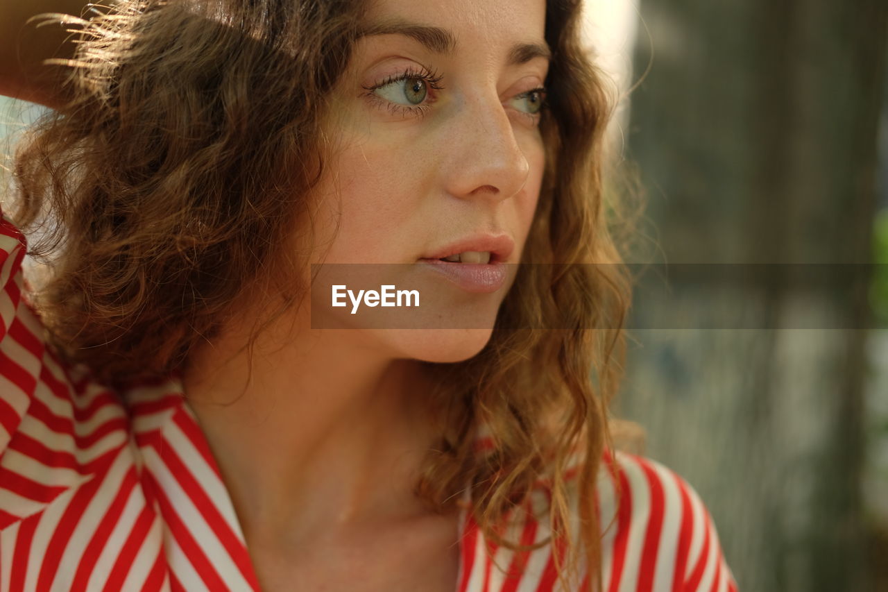 Close-up of young woman looking away