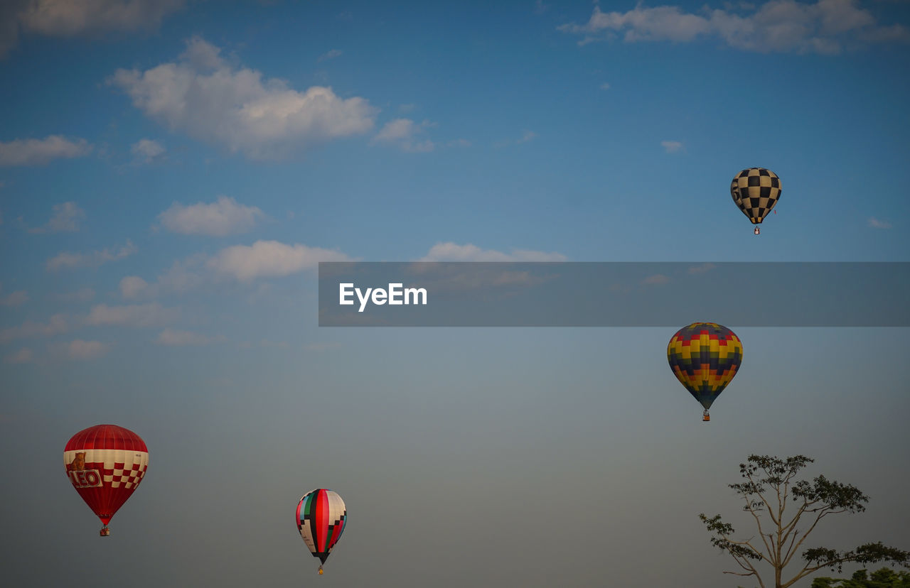 LOW ANGLE VIEW OF HOT AIR BALLOONS IN SKY