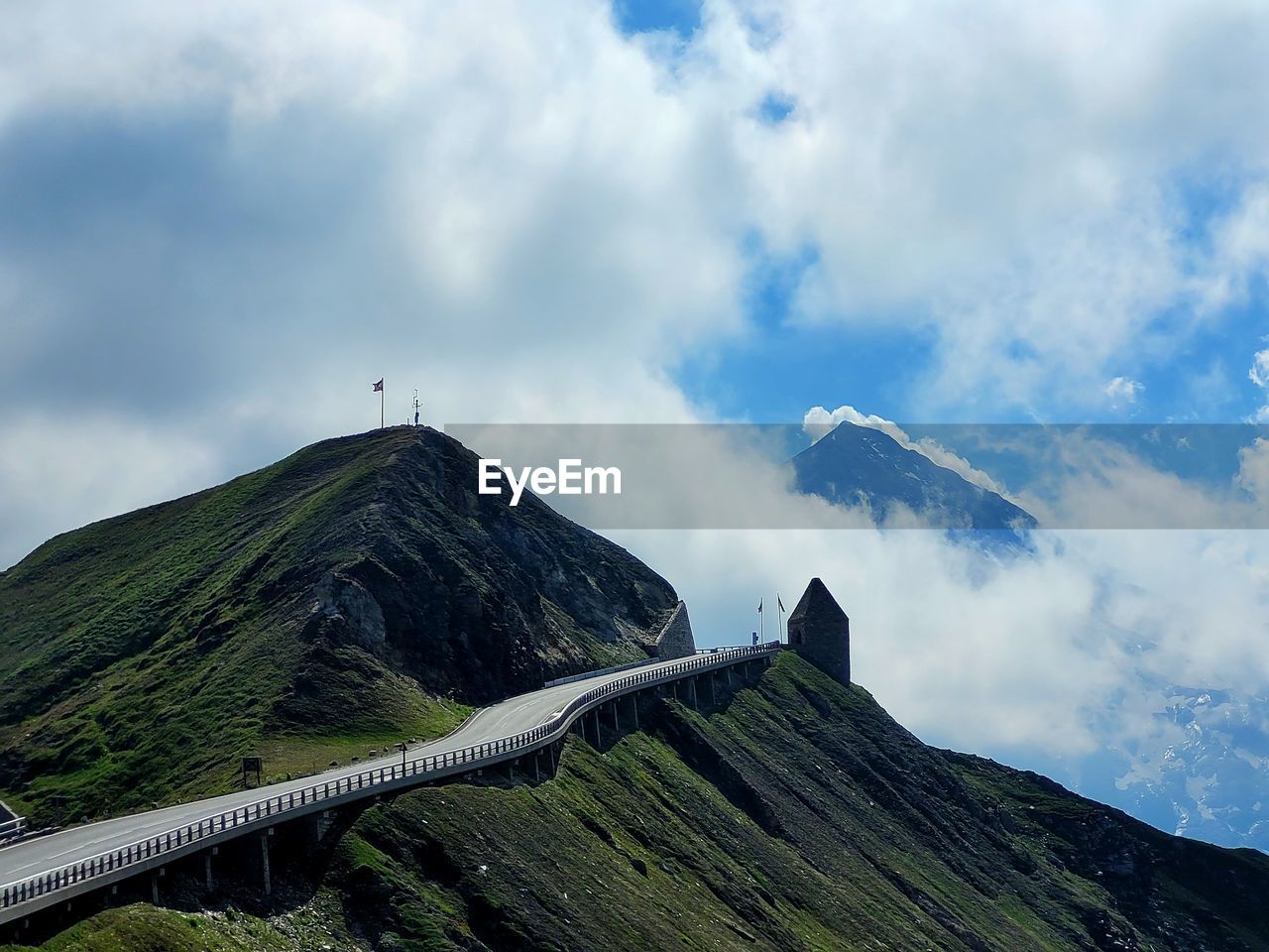 mountain, cloud, sky, mountain range, environment, scenics - nature, landscape, nature, beauty in nature, travel, travel destinations, land, ridge, no people, non-urban scene, mountain pass, tourism, outdoors, volcano, architecture, mountain peak, transportation, day, tranquility, highland, built structure, tranquil scene, social issues, geology, plant, adventure, activity, fog, volcanic landscape, summit, blue, idyllic