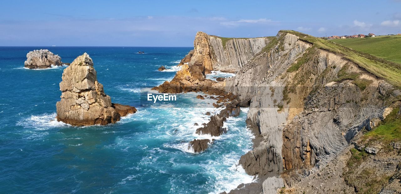 Panoramic view of rocks on beach against sky