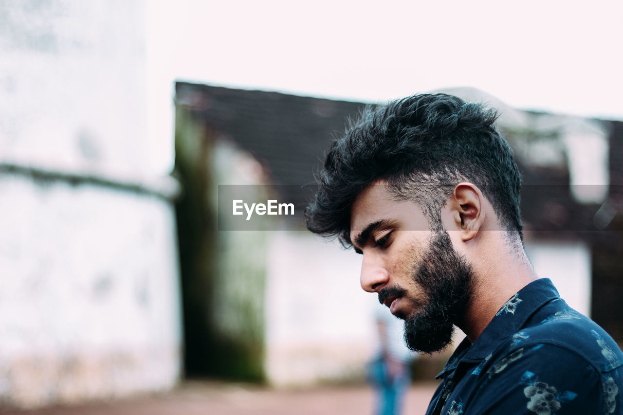 PORTRAIT OF HANDSOME YOUNG MAN LOOKING AWAY