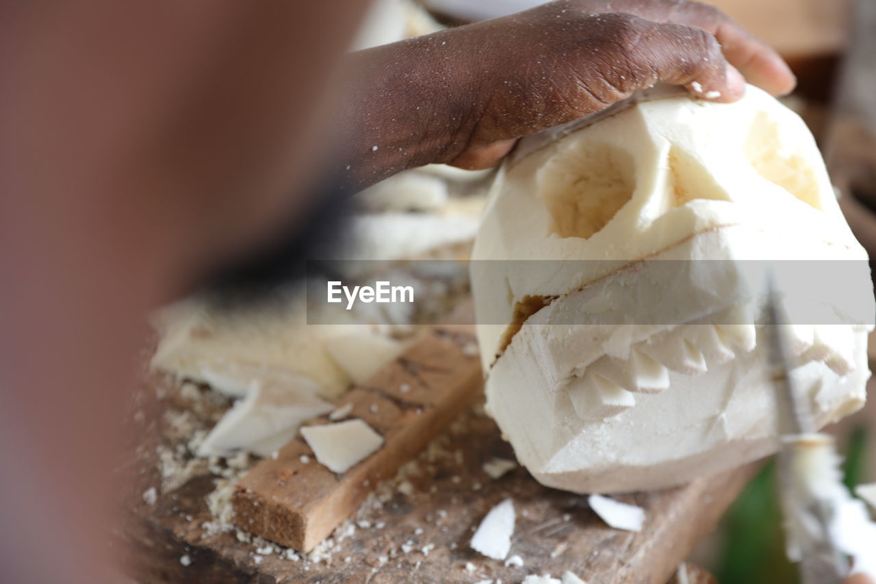 CLOSE-UP OF HAND HOLDING CHOCOLATE CAKE