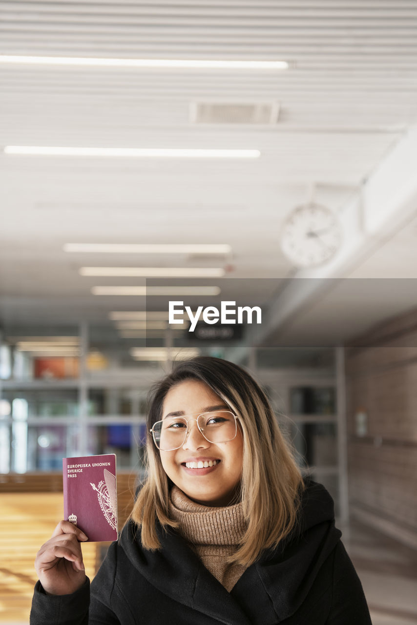 Smiling woman holding passport