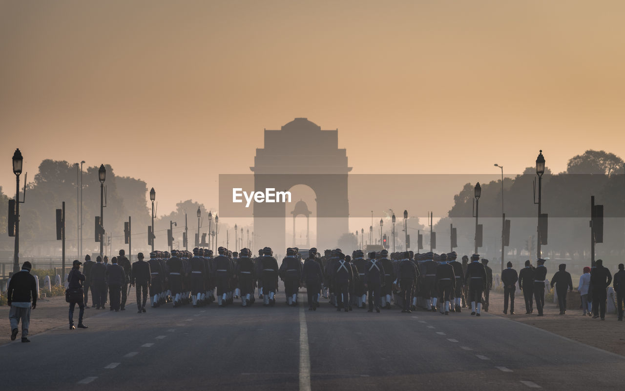 Rear view of army soldiers at india gate during sunrise