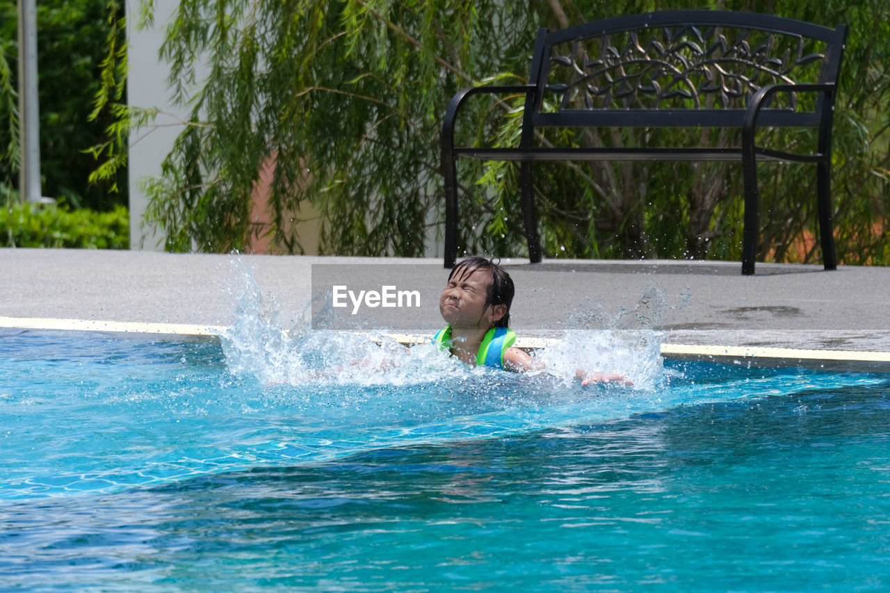 high angle view of boy playing in pool