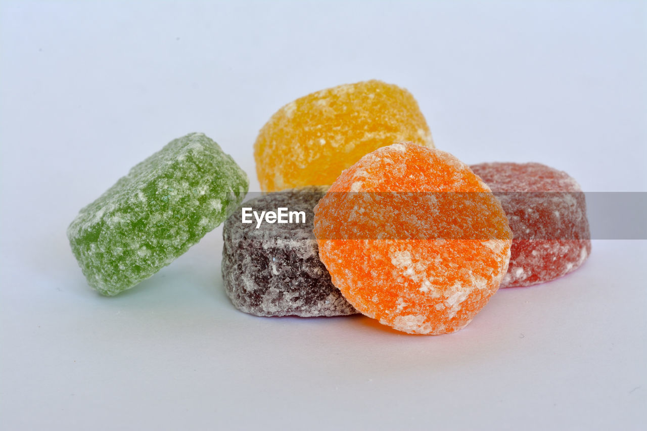 Close-up of candies against white background