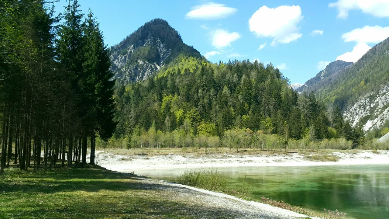 Scenic shot of calm countryside lake against mountain range