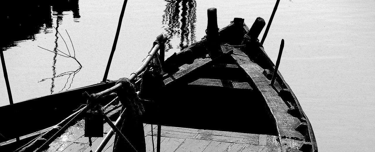 Close-up of boat sailing on lake against clear sky