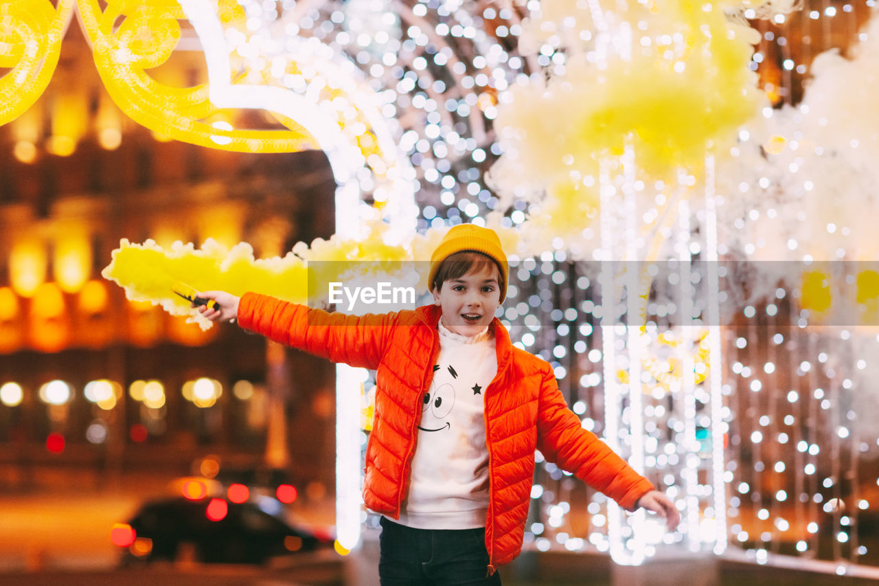 A teenage boy with a smoke bomb in his hands during the celebration of christmas 