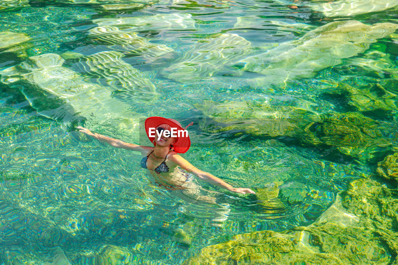 high angle view of woman swimming in water