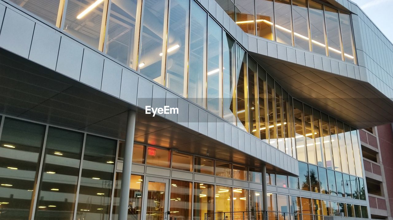 LOW ANGLE VIEW OF MODERN BUILDINGS AT NIGHT