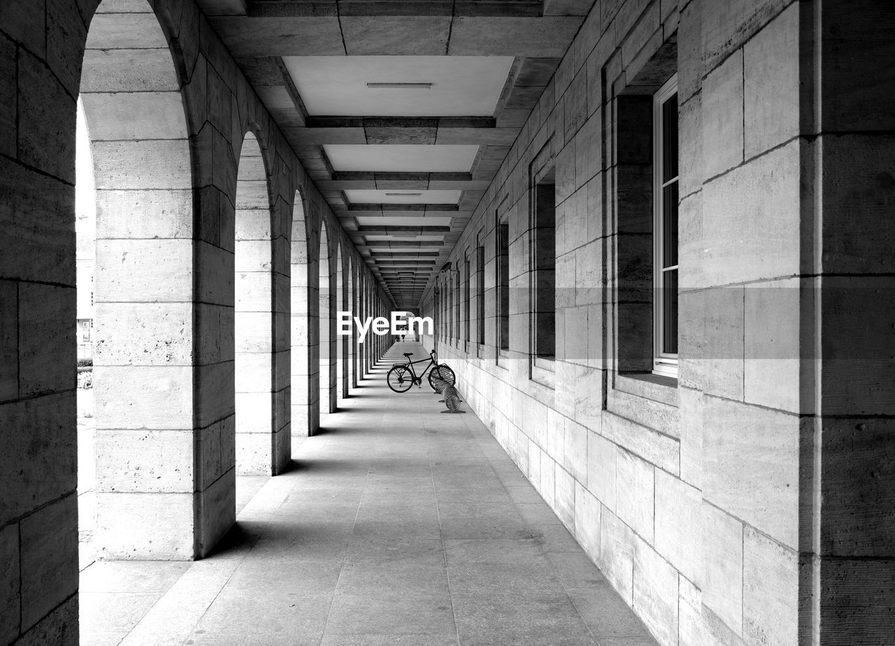 Rear view of man walking on corridor of building