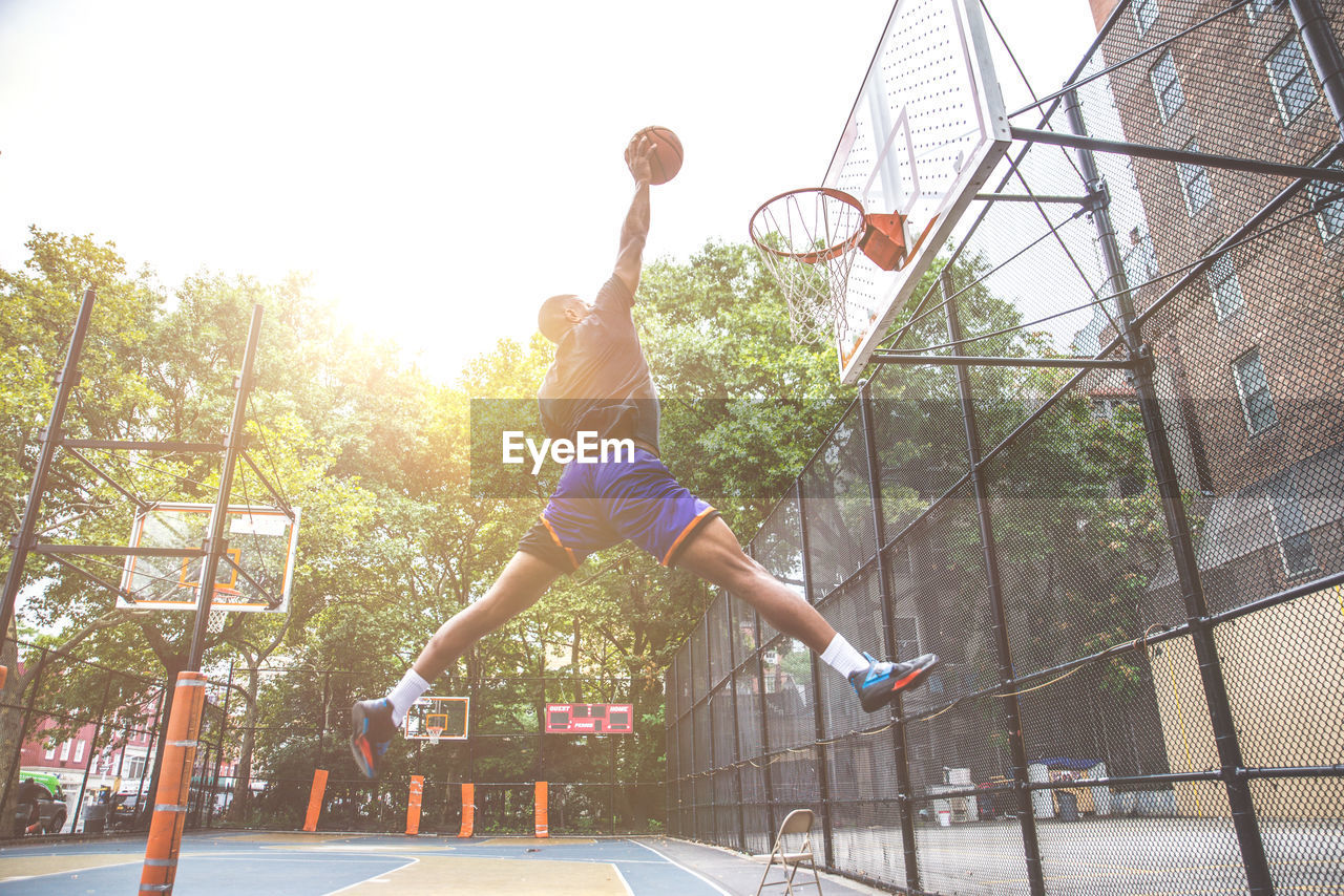 Young man playing basketball in court