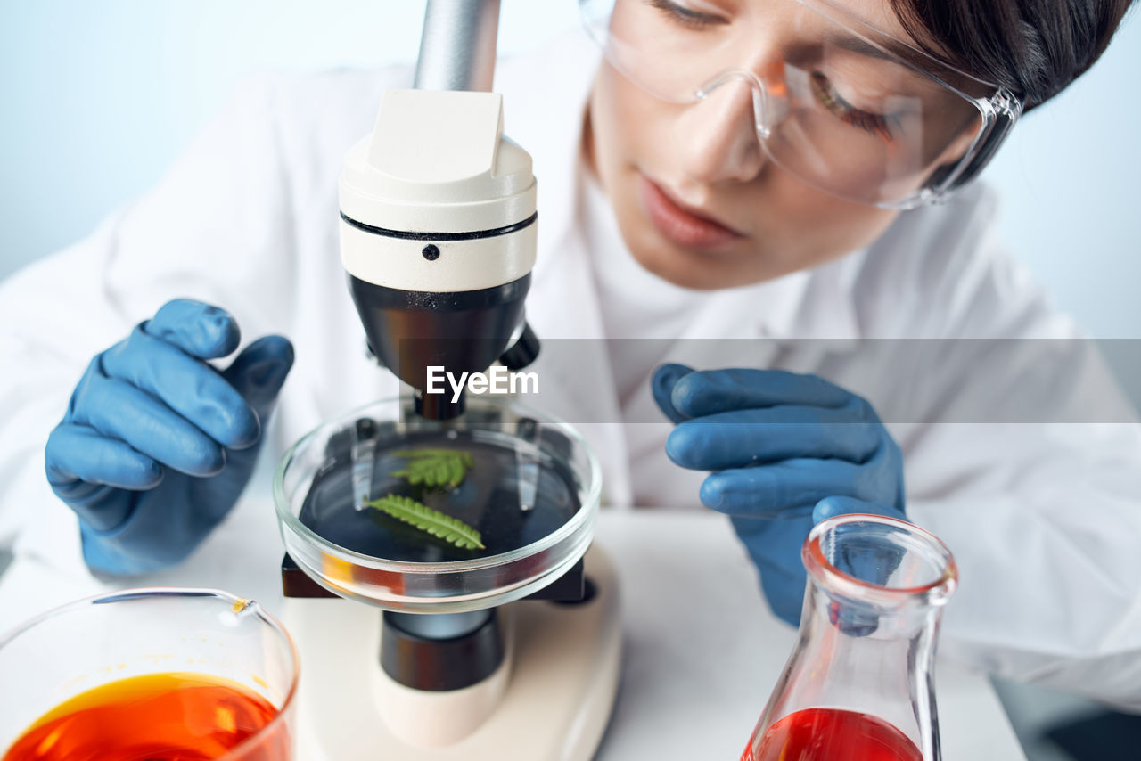 midsection of scientist examining patient in laboratory