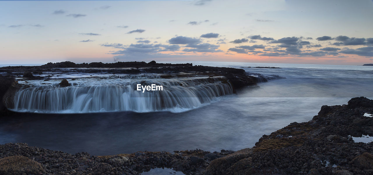 Scenic view of sea against sky at sunset