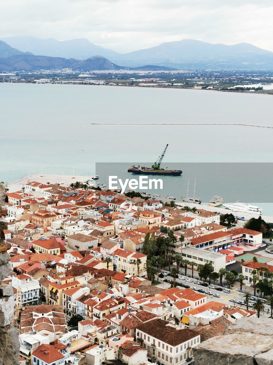 High angle view of townscape by sea against sky