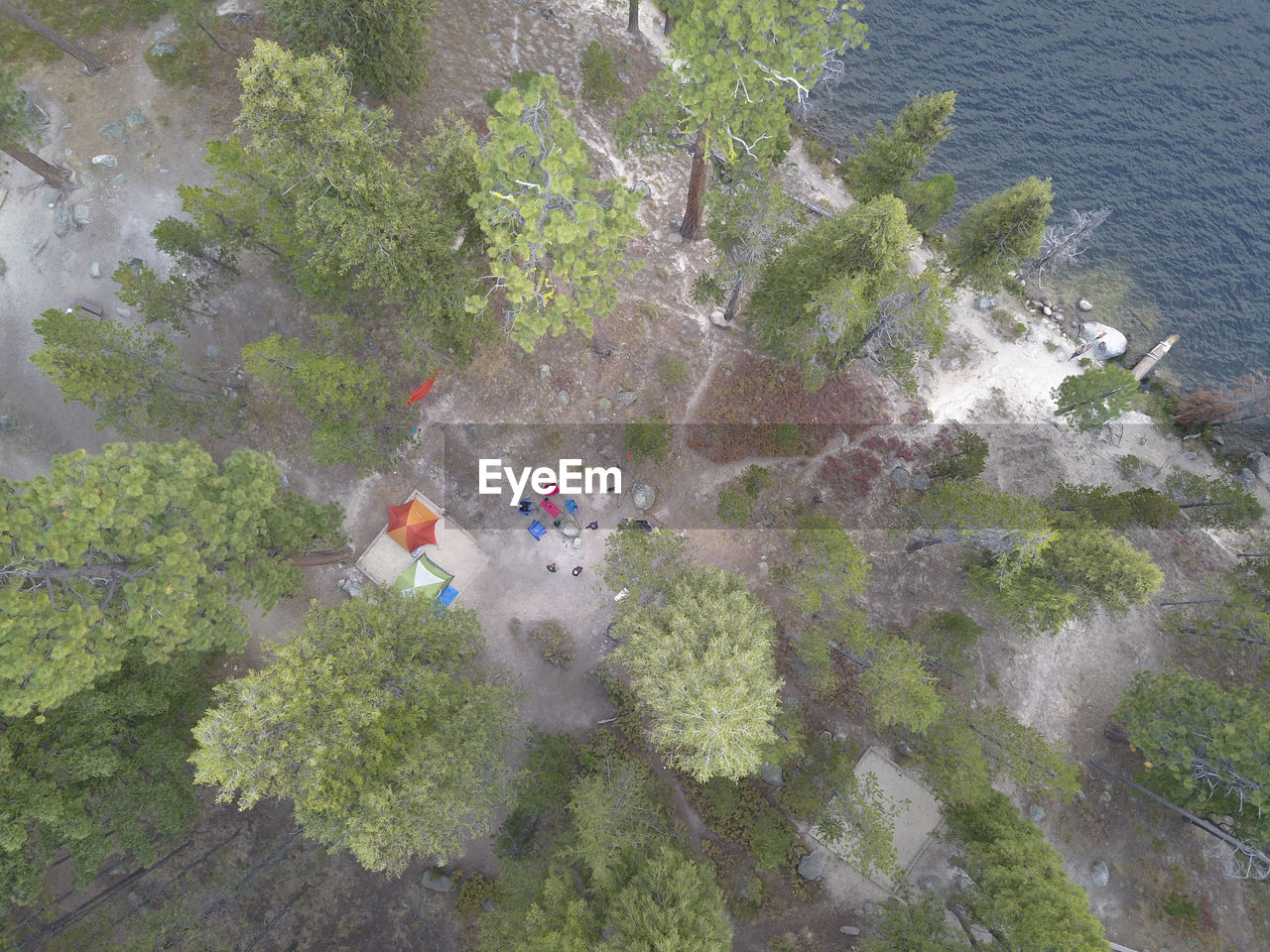 Top-down aerial of a lakeside campsite