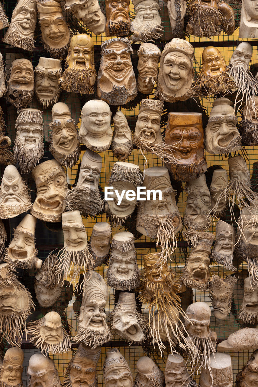 full frame, large group of objects, backgrounds, ancient history, wood, abundance, no people, arrangement, pattern, retail, craft, day, temple, outdoors, for sale