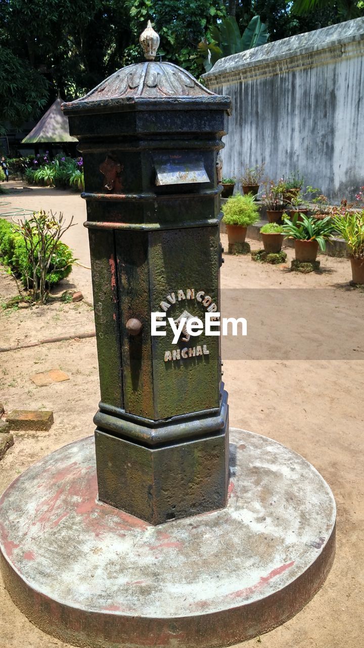 CLOSE-UP OF MAILBOX ON STONE WALL BY PARK